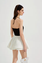 Black halterneck knit top with lace panels