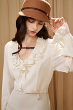 Beige V-Neck Blouse with Belt Buckle & Ruffle Trim