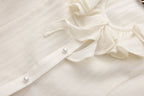 Beige V-Neck Blouse with Belt Buckle & Ruffle Trim