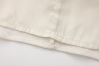 Beige V-Neck Blouse with Belt Buckle & Ruffle Trim