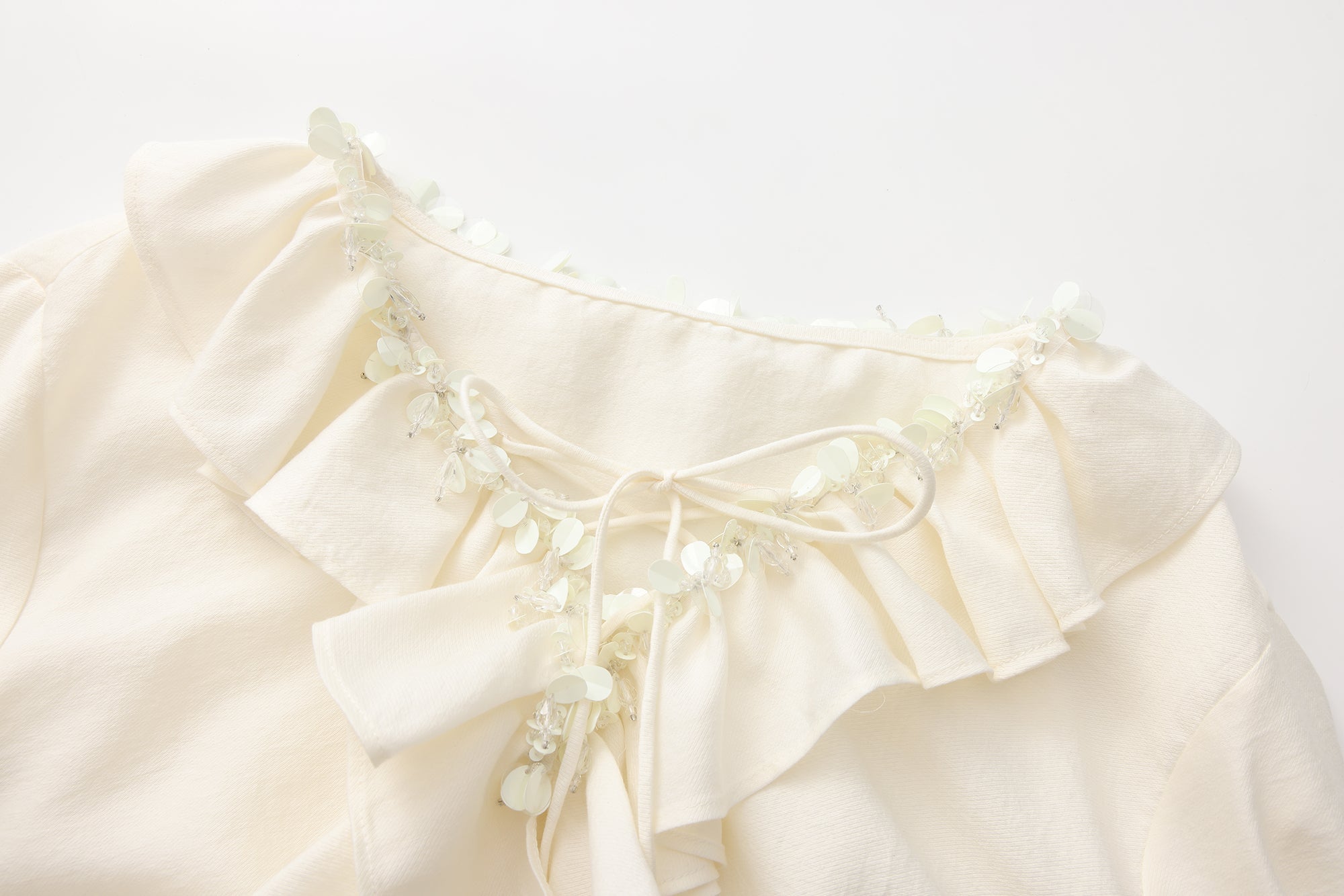 Oversized V-Neck Tie Top with Sequin Ruffle Trim